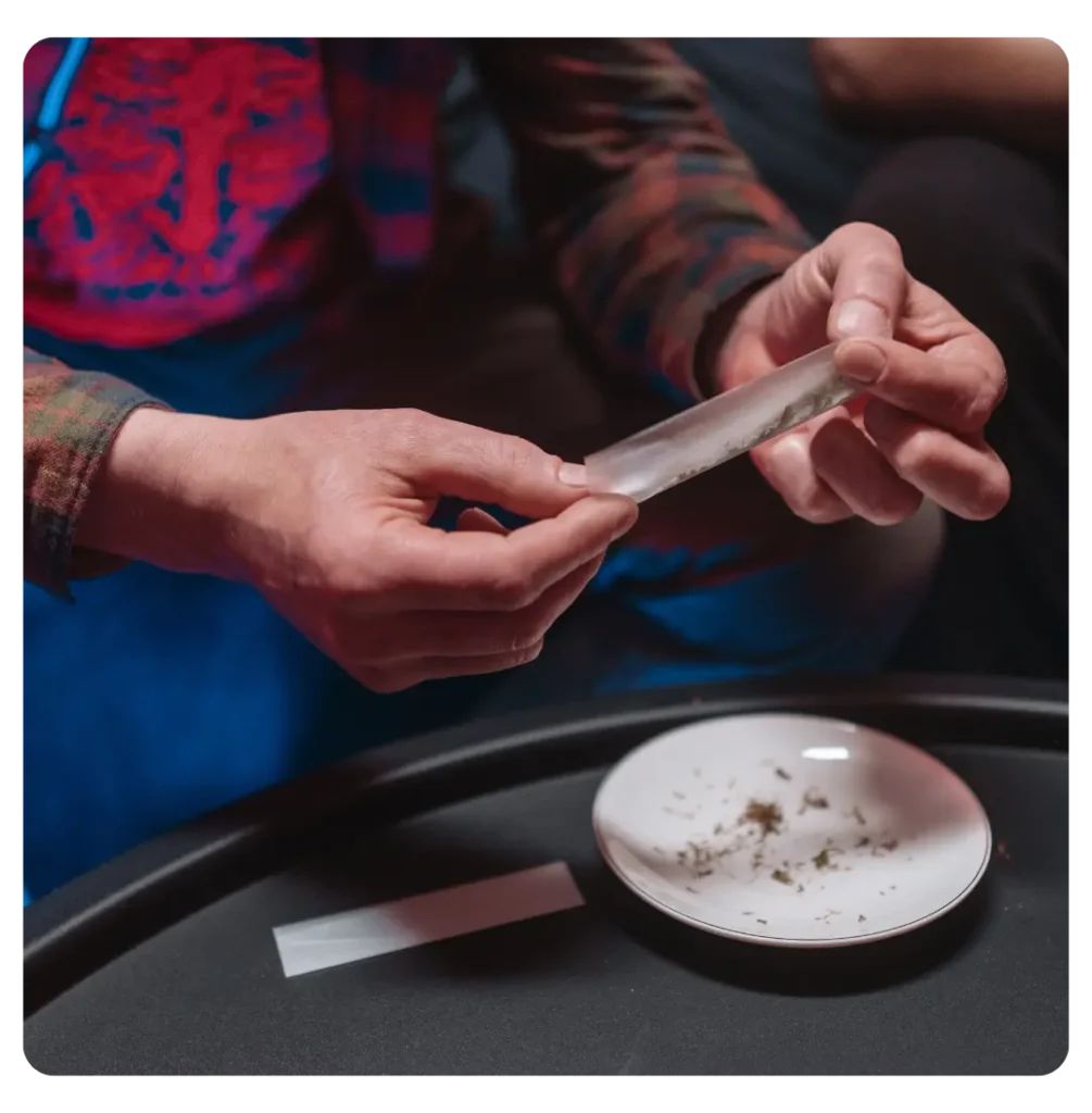 person rolling up cannabis